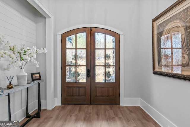 entryway featuring light hardwood / wood-style floors and french doors