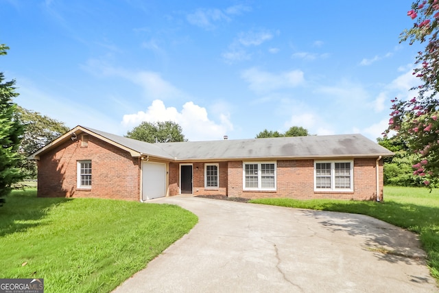 ranch-style house with a garage and a front lawn