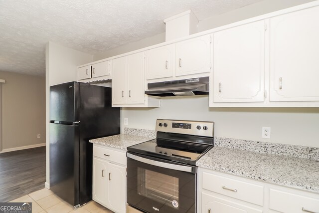 20 Oak Wood Ln, Covington, GA 30016 - kitchen with light stone counters, stainless steel range with electric stovetop, a textured ceiling, black refrigerator, and white cabinets