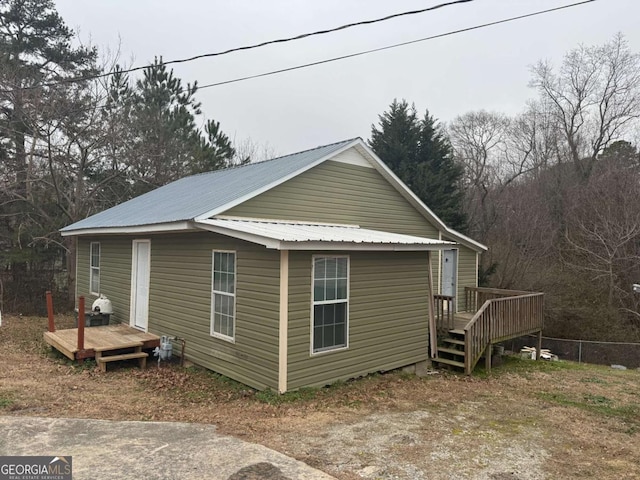 view of home's exterior featuring metal roof and a wooden deck