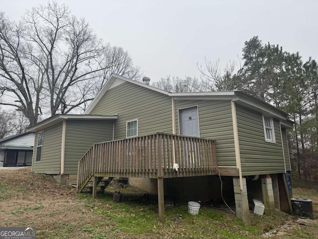 back of house with a wooden deck