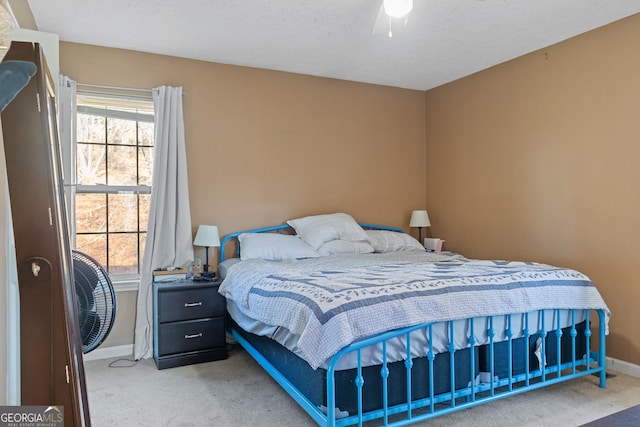 bedroom featuring carpet floors and a textured ceiling