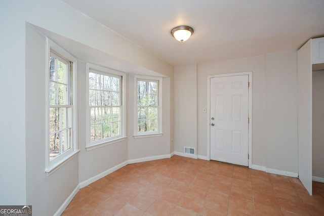 spare room with light tile patterned floors