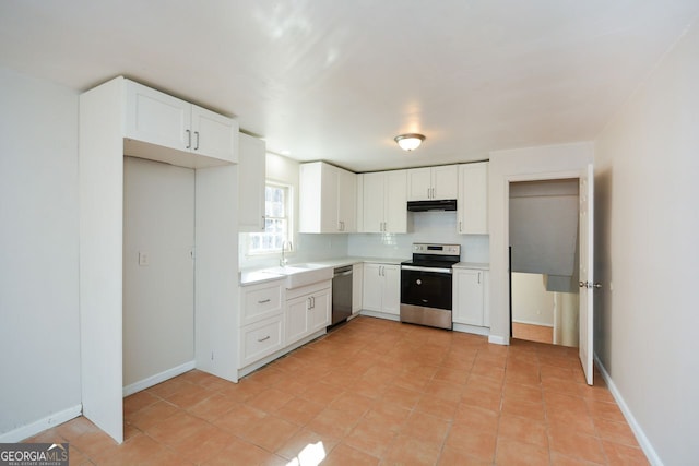 kitchen with stainless steel appliances, tasteful backsplash, sink, and white cabinets