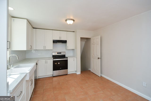 kitchen with electric stove, sink, tasteful backsplash, and white cabinets