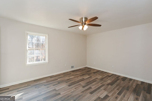 spare room with ceiling fan and dark hardwood / wood-style flooring