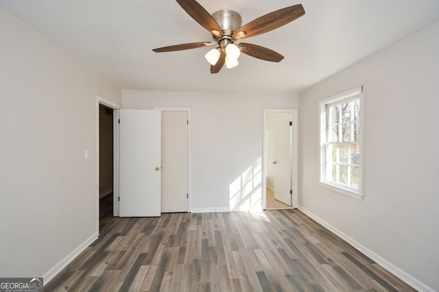 unfurnished bedroom with dark hardwood / wood-style floors and ceiling fan