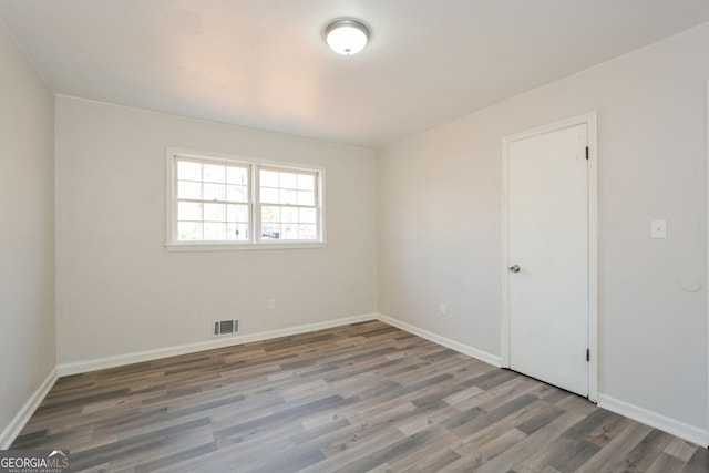 spare room featuring dark hardwood / wood-style floors