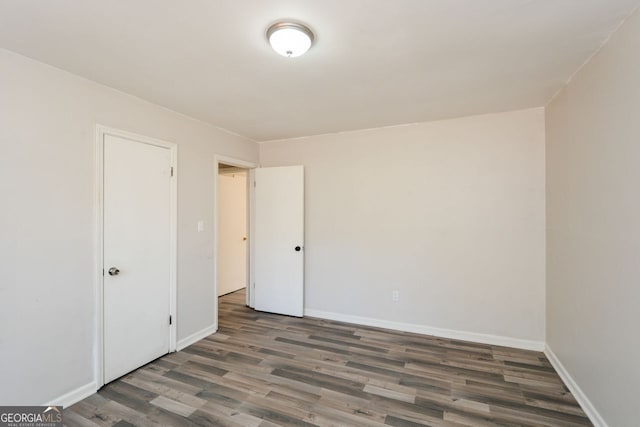 empty room featuring dark wood-type flooring