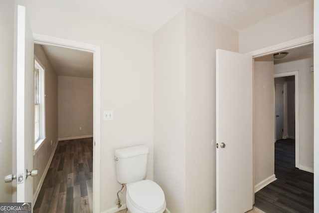 bathroom featuring wood-type flooring and toilet