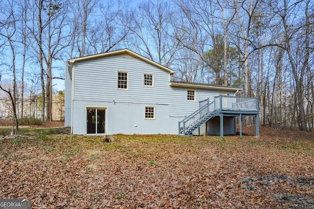 rear view of property featuring a wooden deck