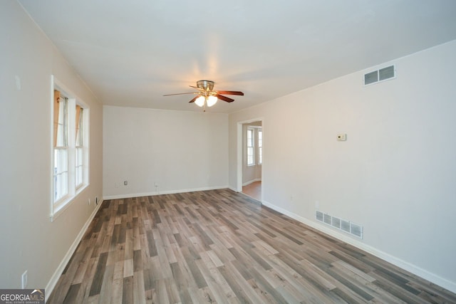 empty room featuring hardwood / wood-style floors and ceiling fan