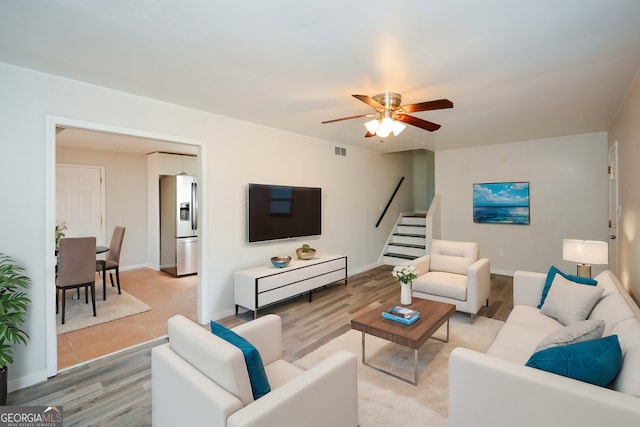 living room featuring light hardwood / wood-style floors and ceiling fan