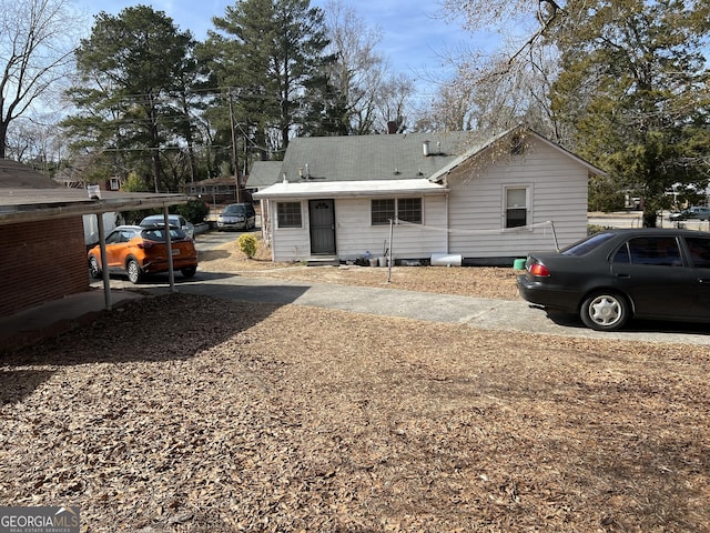 rear view of property featuring a carport