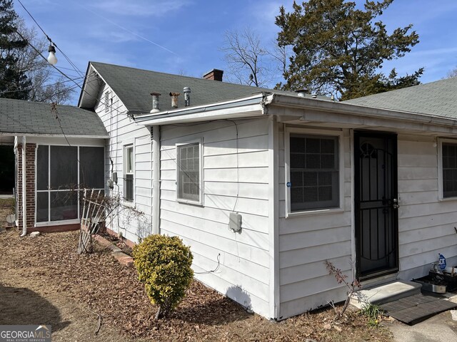 view of property exterior featuring a sunroom