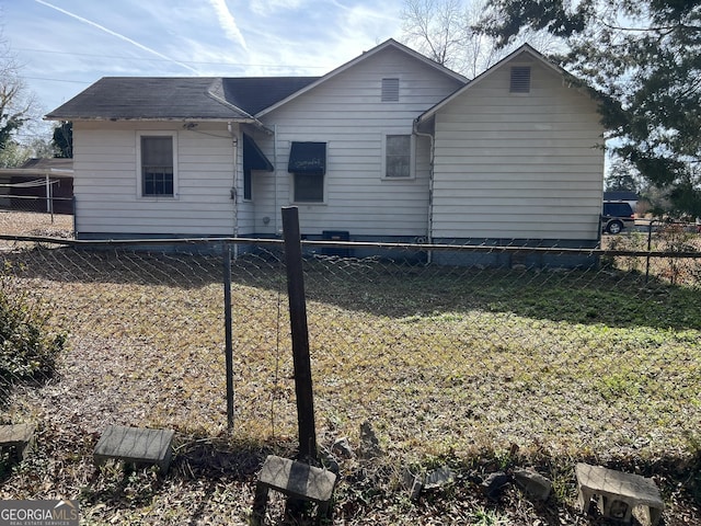 back of property with a lawn