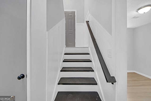 staircase featuring hardwood / wood-style floors