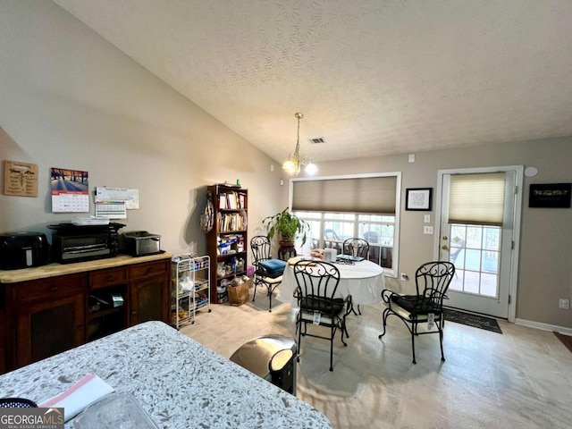 dining room with lofted ceiling, a textured ceiling, and a notable chandelier