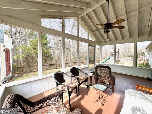 sunroom with ceiling fan and vaulted ceiling with beams