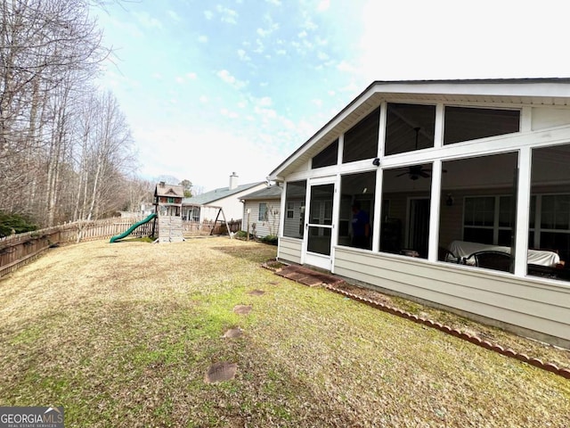 view of yard featuring a sunroom and a playground