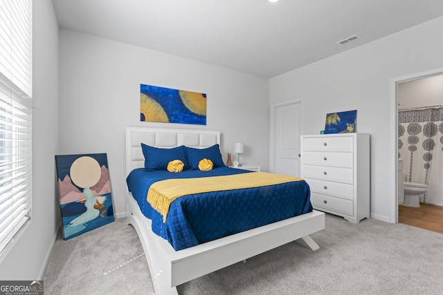 carpeted bedroom with connected bathroom