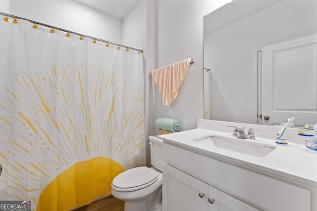 bathroom featuring vanity and toilet