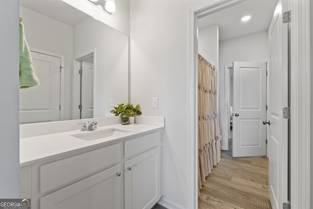 bathroom featuring vanity and wood-type flooring