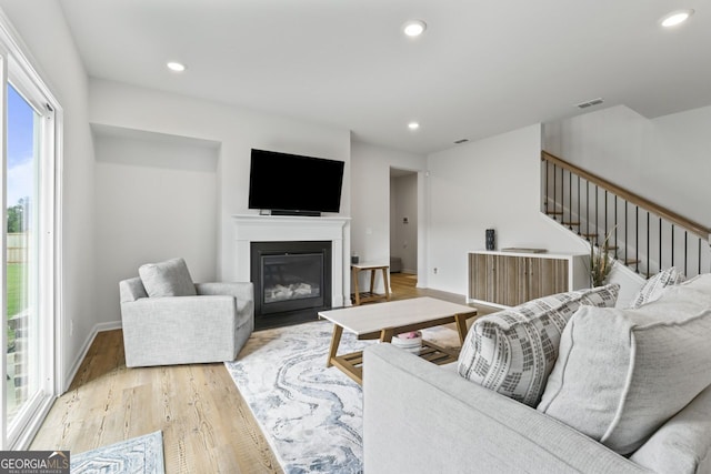 living room with plenty of natural light and light hardwood / wood-style flooring