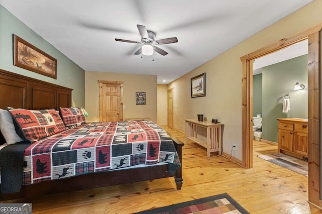 bedroom with ensuite bathroom, ceiling fan, and light hardwood / wood-style flooring