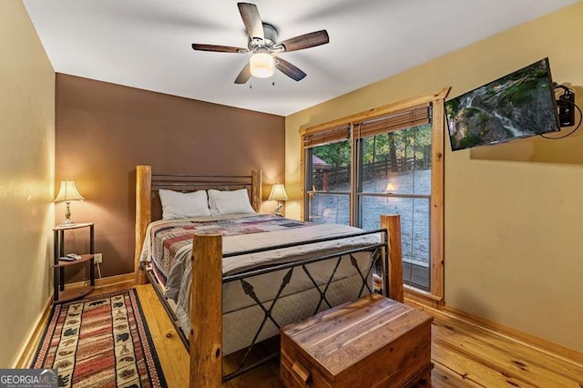 bedroom with ceiling fan and wood-type flooring