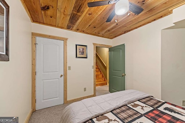 bedroom with ceiling fan, light carpet, and wooden ceiling