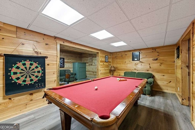 playroom with pool table, wood-type flooring, a drop ceiling, and wood walls