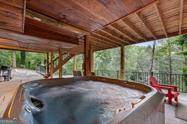 view of patio / terrace with a grill and a hot tub