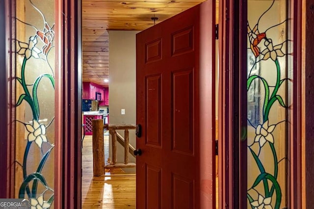 hall featuring wooden ceiling and light wood-type flooring