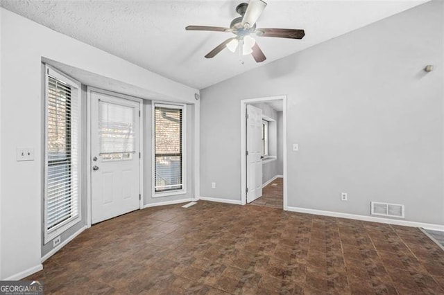 interior space with vaulted ceiling and ceiling fan