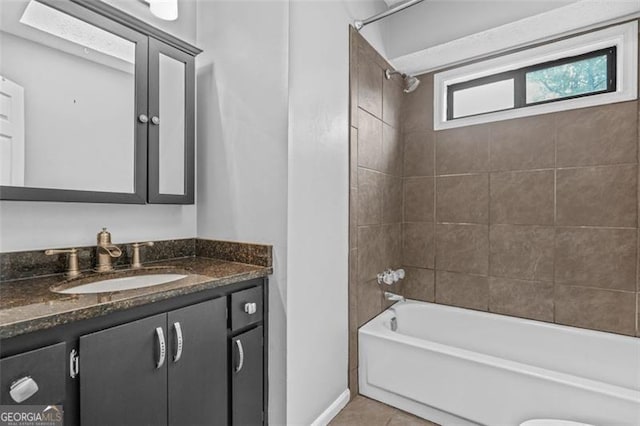 bathroom featuring tile patterned floors, vanity, and tiled shower / bath combo