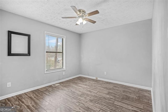 unfurnished room with hardwood / wood-style floors, a textured ceiling, and ceiling fan