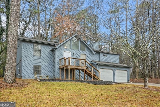 view of front of house with a garage and a front lawn