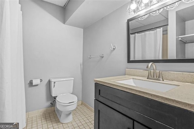 bathroom featuring tile patterned flooring, vanity, and toilet