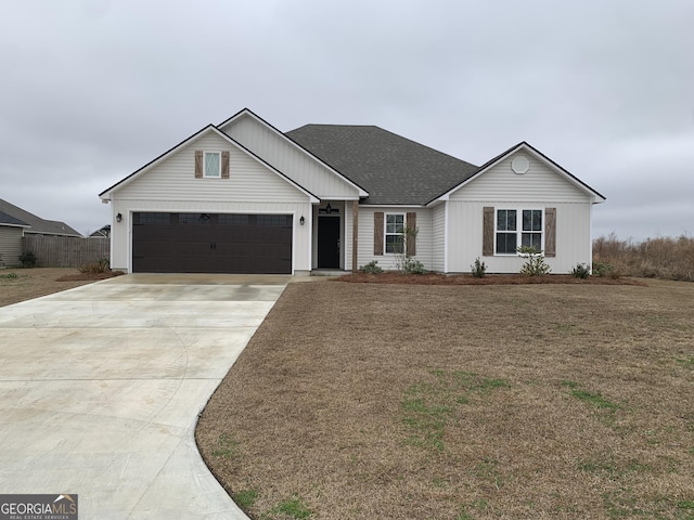 view of front of home featuring a garage and a front lawn