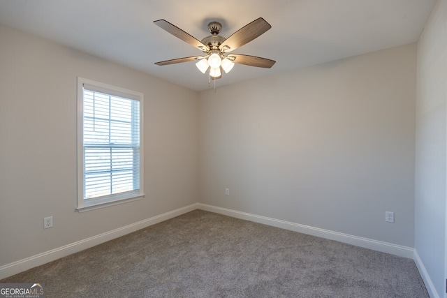 carpeted empty room featuring ceiling fan