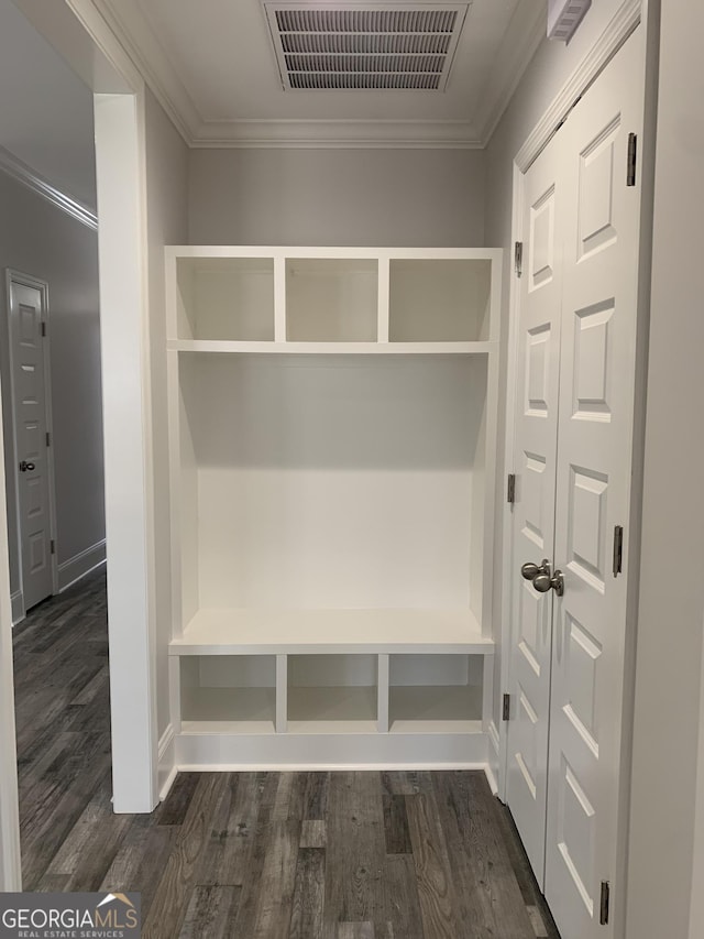 mudroom featuring dark wood-type flooring and ornamental molding