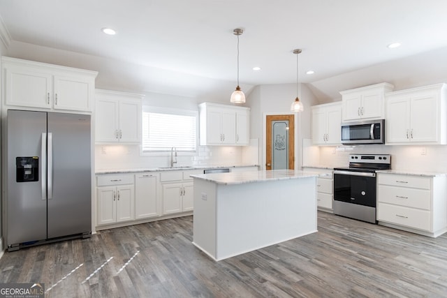 kitchen featuring white cabinetry, appliances with stainless steel finishes, and decorative light fixtures