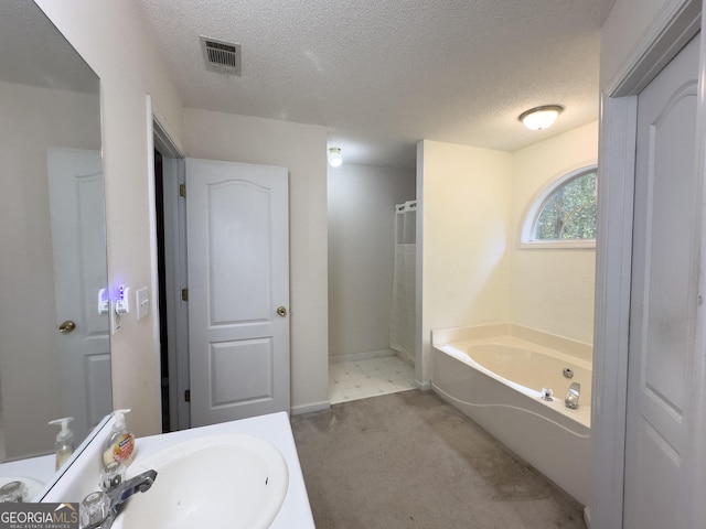 bathroom featuring sink, shower with separate bathtub, and a textured ceiling