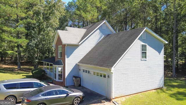 view of home's exterior with a garage and a yard