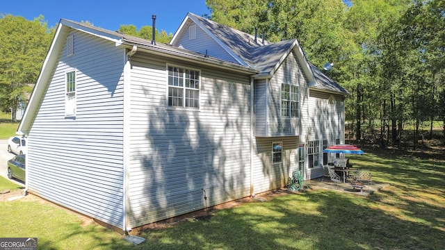 view of side of property with a yard