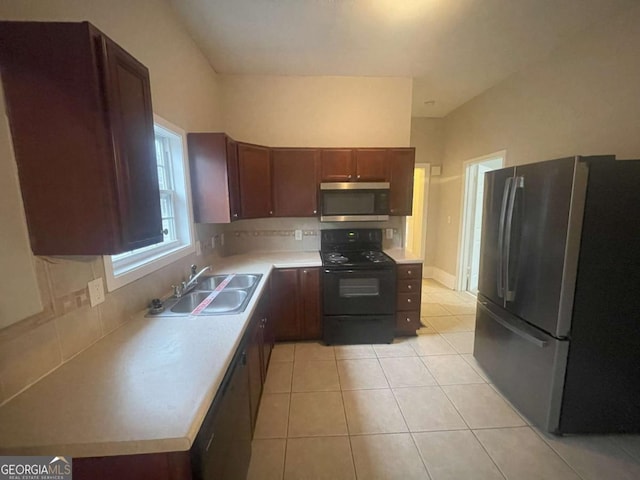 kitchen featuring sink, backsplash, stainless steel appliances, and light tile patterned floors