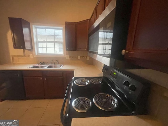 kitchen with sink, light tile patterned floors, and black / electric stove