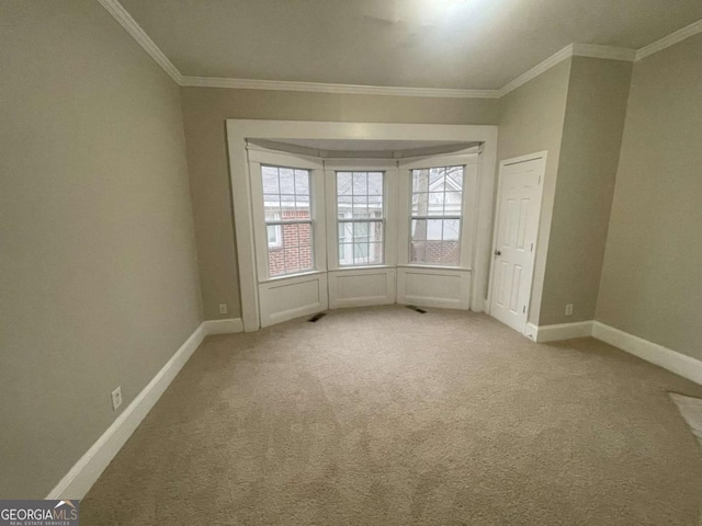 spare room with carpet floors and ornamental molding