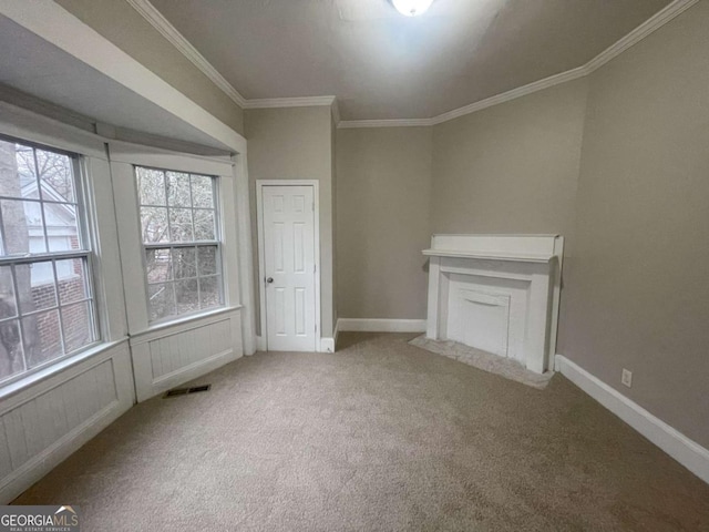 unfurnished living room featuring ornamental molding and carpet flooring